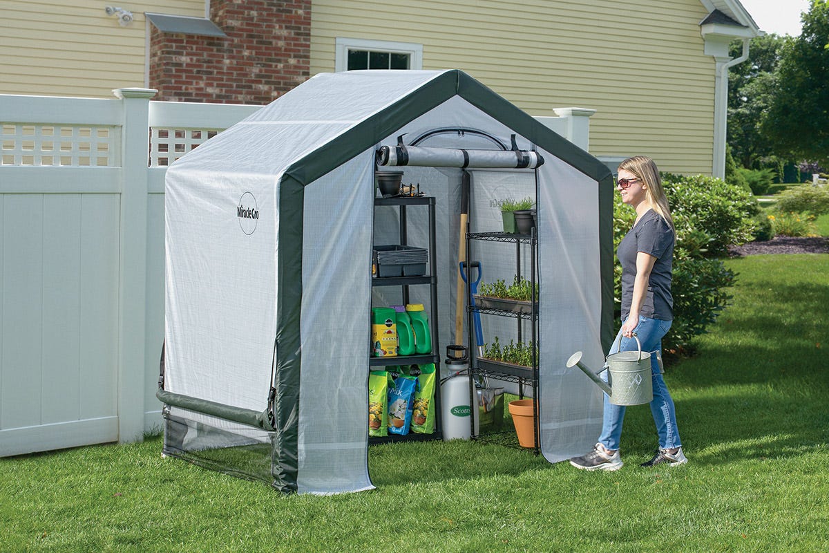 Scotts Miracle-Gro Greenhouse Lady walking with a watering can