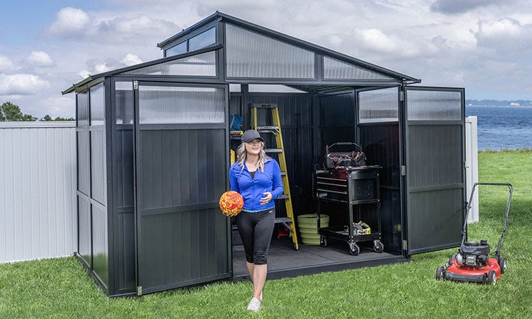 A woman standing outside a Sojag Rainier Shed